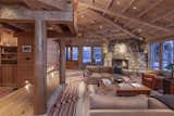 Exposed support beams throughout the residence enhance its rustic, cabin-inspired style.