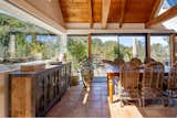 Large, sliding glass doors connect the dining area with the adjacent deck.  Photo 6 of 14 in A Wooded Retreat With Two Shingle-Clad Homes Seeks $1.7M in Carmel