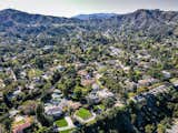 An aerial view highlighting the property's mountainous location. "The design, floor plan, tree-filled setting and being so close to the Rose Bowl makes the homes especially remarkable," adds Parker-Stanton.