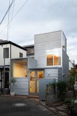 In addition to opening House Tokyo up to natural light, the large windows break up the corrugated metal facade.