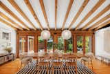 Original cedar beams take center stage in the dining area, which overlooks the backyard.