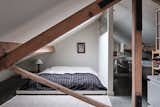A large skylight is positioned over the primary bedroom on the pitched-roof mezzanine level.