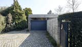 The cobble-stone driveway leads to the attached garage and side garden entrance—practically the only features of the home visible from street-view.  Photo 3 of 13 in A ’60s Time Capsule by Belgian Brutalist Juliaan Lampens Lists for €545K