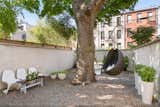 The French-style garden offers several peaceful lounge areas. "Out back, it’s easy to forget you’re in Brooklyn," notes the current homeowner.
