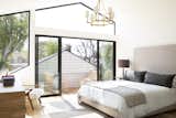 In the principal suite, expansive glass doors open to a private balcony that is hidden behind the original structure’s roofline. The bedroom windows are pre-wired for automatic shades.