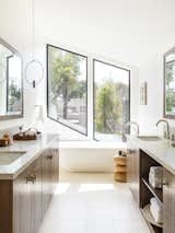 Custom vanities with Walker Zanger stone countertops add a sleek touch in the principal bathroom.&nbsp;