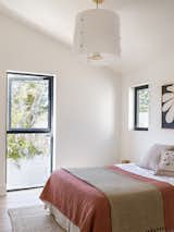 The bedrooms are located at the rear of the house and feature double-height ceilings.