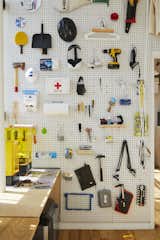 In the New York loft that he shares with two friends, industrial designer Joshua Skirtich covered one wall of his 8-by-11 bedroom/ design studio with a pegboard for organizing his tools. A plywood desk runs the length of the room, accommodating Joshua’s 3D-printing equipment at one end and clothing drawers at the other.