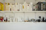 A wall of shelves holds color-blocked books, 3D-printed prototypes (including several versions of Joshua’s soy sauce cruet), and objets the designer has collected over the years, like a 1937 Top-O-Stove Potato Baker by Raymond Barton and salt and pepper shakers by William Lescaze.