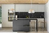 A pair of Splügen Braü pendants from Flos hang near a kitchen island topped with black Swedish granite. The faucets are from Vola and the appliances are from Siemens.