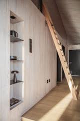A ladder rises to a lofted bedroom that doubles as a kids’ play area.