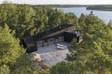 Exterior, House Building Type, Shed RoofLine, Wood Siding Material, and Flat RoofLine The house is balanced atop a rocky slope. “Not one millimeter of rock was blasted away,” says Rickard, who deferred to the topography in his design.  Photo 3 of 15 in An Architect’s Weekend Home Balances on a Rocky Slope in the Stockholm Archipelago