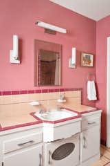 The first-level bathroom is dressed in original tile, which adds a playful burst of color.&nbsp;