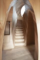 A narrow staircase connects the main floor with the pod’s upper level and intersects the entryway to form another captivating, carved-out space.