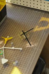 A clock engine sits next to Joshua’s Do-Nothing Machine in his workspace. A riff on the Eames Solar Do-Nothing Machine, the item attaches to a window “to make the world seem less boring,” Joshua says.