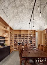 Dining, Pendant, Chair, Concrete, Table, Shelves, and Bar  Dining Chair Bar Concrete Photos from A Private Wine Cave Is Built Into a Limestone Hillside in Texas