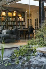 The pond off of the living room was designed by Sarah’s landscape studio and installed by Active Landscapes and Ponds.  Photo 4 of 14 in furniture from An 11-Year Renovation Helps a Couple Grow Simpatico With the Original Homeowner’s Quirky Vision