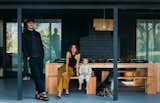 Carlos Naude and Whitney Brown enjoy the outdoor dining area with their son, Rico, and dog, Mona. Kinto table settings complete the tableau.
