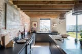 Wooden beams add rustic flair to the sleek corner, paying homage to the home's agrarian roots.  Photo 6 of 15 in An Idyllic “Glass Barn” in the English Countryside Asks £2.3M