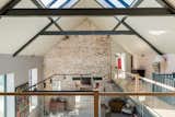The mezzanine area is accessed via a dramatic walkway with glass balustrades.  Photo 12 of 15 in An Idyllic “Glass Barn” in the English Countryside Asks £2.3M
