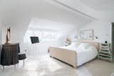 Situated under a pitched roof, the primary bedroom spans the entire third level of the home.