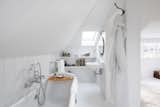 A freestanding tub awaits in the primary bedroom’s en suite bathroom.