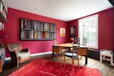 A large picture window sweeps an abundance of natural light into the office.