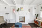 The painted brick fireplace that anchors the living room now serves as clever storage space.
