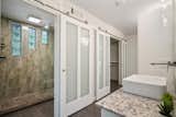 In the bathroom, two sets of sliding doors unveil an oversize shower and a walk-in closet.