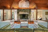 The broad stone fireplace soars to the ceiling, enhancing the room's overall sense of space.  Photo 4 of 12 in A Dazzling Home by Frank Lloyd Wright’s Final Apprentice Lists for the First Time