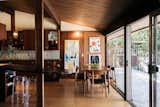 Floor-to-ceiling glass doors span across the wall, opening the dining area up to the rear terrace.  Photo 8 of 13 in A Beguiling Midcentury in L.A. Hits the Market for the First Time Ever