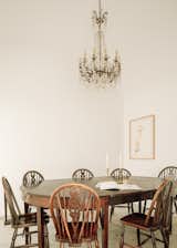 An antique chandelier hangs above the dining area, located steps from the kitchen.