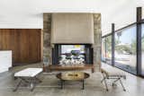 A double-sided, Bouquet Canyon stone-clad fireplace links the living and dining spaces.