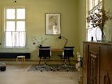 The large home office is cloaked with a serene shade of green and fitted with antique furniture.&nbsp;