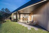 A perfectly groomed backyard lawn with a paver patio. 