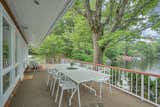 A spacious terrace overlooking the lake provides an idyllic setting for alfresco dining.