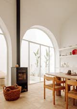 Two beautifully preserved arches with glass doors and windows establish an indoor/outdoor connection between the patio and open-plan living spaces.