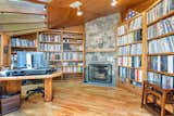 Another fireplace can be found in the wood-clad library, where custom built-ins line the walls.