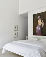 The primary suite is also outfitted in an all-white palette with eye-catching artwork.
