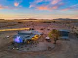 An aerial view of the property highlights its secluded desert setting. In total, the home comes with 10 acres, as the five-acre parcel to the east is also included in the sale.