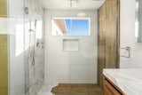 The primary bedroom has an en suite bath that features a marble-tiled shower and walk-in closet.