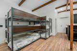 The queen-size bunkbed units sit nestled in the corner, with a full bathroom is located steps away.