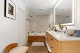 The en suite bathroom includes a double-sink vanity, oversize soaking tub, and walk-in closet.
