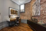 Exposed brick continues into the home office—another bright and airy space with tall ceilings.