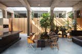 The dining table was designed by MASA Architects. It features a structural glass manufactured by Van Dijken Glas in a color gradient of black to brown.