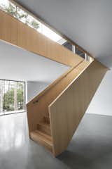 Staircase, Wood Tread, and Metal Railing  Photo 11 of 17 in A Cathedral-Esque Lake Home Rises in the Quebec Countryside