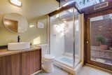 One of the home’s three bathrooms features an oversize glass shower.