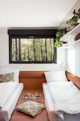 A black-framed window pops against the trailer’s surrounding white walls and wooden accents.