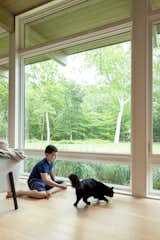 The couple’s son, Spencer, and the family cat in the home’s sunny living room on the lower level.&nbsp;