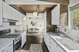The galley kitchen comes with all new appliances, a ceramic backsplash, and plentiful storage.